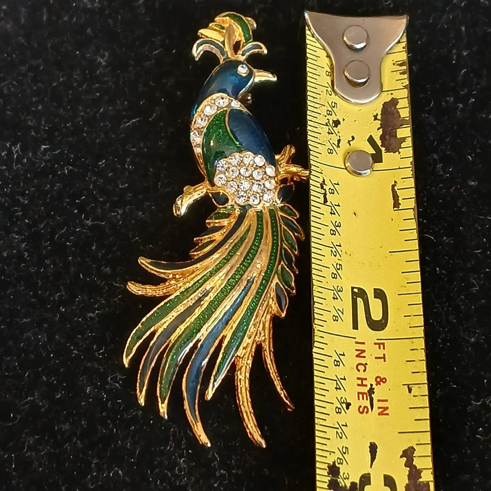 Goldtone peacock brooch with blue and green accents